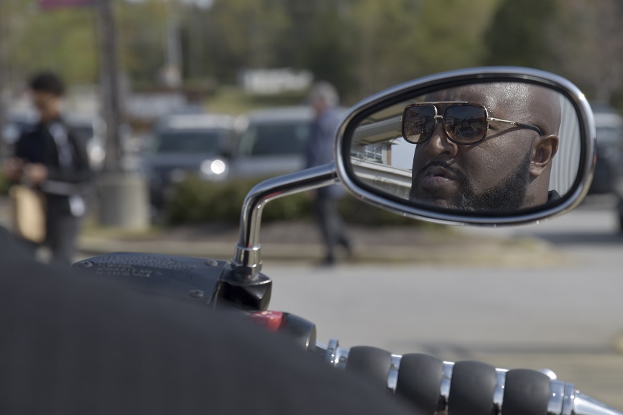 Director Pough in motorcycle mirror